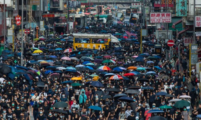 People march along the main road in Mong Kok as they take part in a pro-democracy march from Tsim Sha Tsui in the Kowloon district in Hong Kong on Oct. 20, 2019. (Philip Fong/AFP via Getty Images)