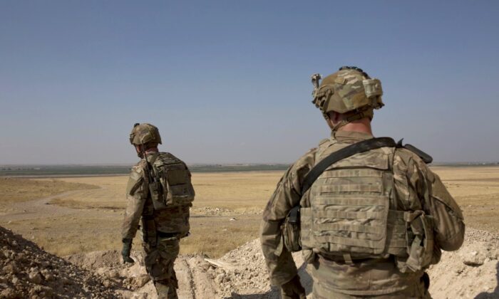 U.S. soldiers survey the safe zone between Syria and the Turkish border near Tal Abyad, Syria, on a joint patrol with the Tax Abyad Military Council, affiliated with the U.S.-backed Syrian Democratic Forces on Sept. 6, 2019. (Maya Alleruzzo/AP Photo)