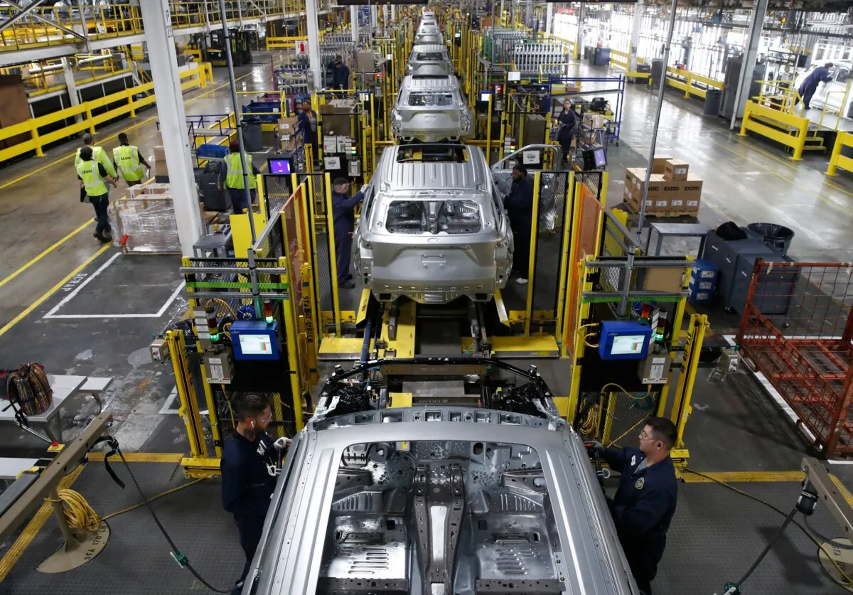 Workers assemble cars at the newly renovated Ford assembly plant in Chicago on June 24, 2019. (JIM YOUNG/AFP/Getty Images)