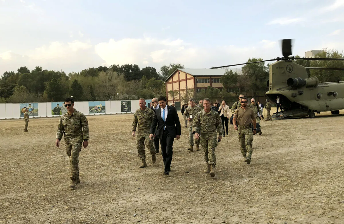 Defense Secretary Mark Esper, center, walks Gen. Scott Miller, right, chief of the U.S.-led coalition in Afghanistan, at the U.S. military headquarters in Kabul, Afghanistan on Oct. 20, 2019. (AP Photo/Lolita C. Balbor)
