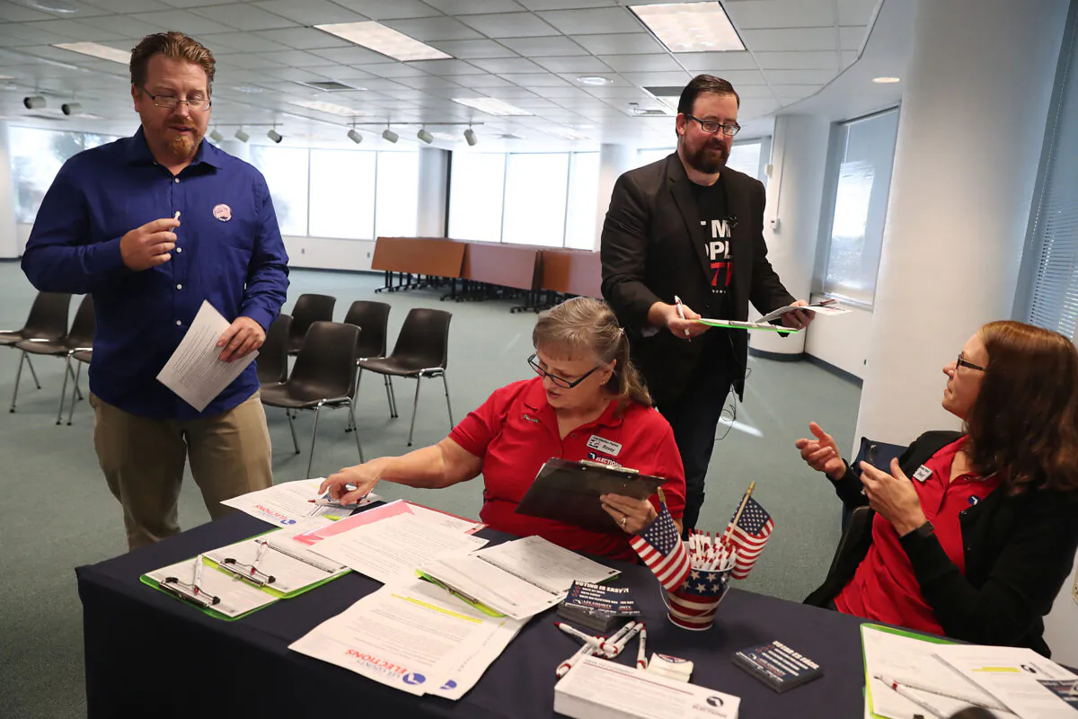 Lance Wissinger (L) and Neil Volz, both with felony records, hand their voter registration forms at the Lee Country Supervisor of Elections office in Fort Myers, Fla., on Jan. 8, 2019.  Joe Raedle/Getty Images