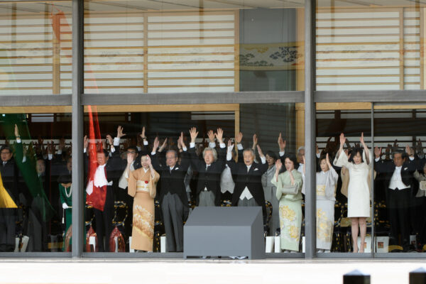 Japanese dignitaries and government representatives raise their arms giving a banzai cheer during the enthronement ceremony of Japan's Emperor Naruhito at the Imperial Palace in Tokyo