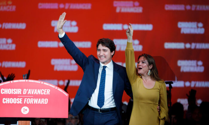 Liberal Leader and Canadian Prime Minister Justin Trudeau waves alongside his wife Sophie Grégoire Trudeau after delivering his victory speech at his election night headquarters in Montreal, Canada on Oct. 21, 2019. (Cole Burston/Getty Images)
