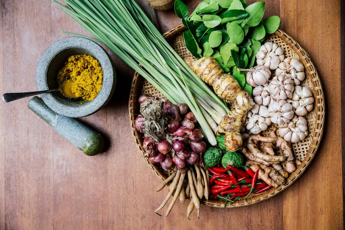 Lemongrass paste, pounded from a mix of herbs and spices, (top) and a selection of other common ingredients in Cambodian cuisine. (Nataly Lee)