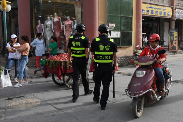 Police officers patrolling in Kashgar City, Xinjiang, China, on June 4, 2019. Authorities in the region have collected DNA samples from residents en masse. (GREG BAKER/AFP/Getty Images)