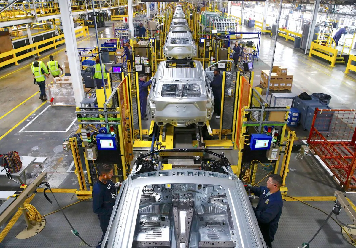 Workers assemble cars at the newly renovated Ford's Assembly Plant in Chicago, Ill., on June 24, 2019. (Jim Young/AFP/Getty Images)