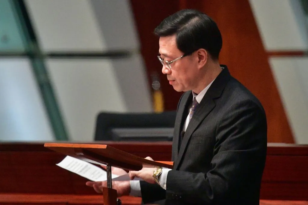 Hong Kong Secretary for Security John Lee lowers his notes after officially withdrawing the extradition bill at the Legislative Council complex in Hong Kong on Oct. 23, 2019. (Anthony Wallace/AFP via Getty Images)