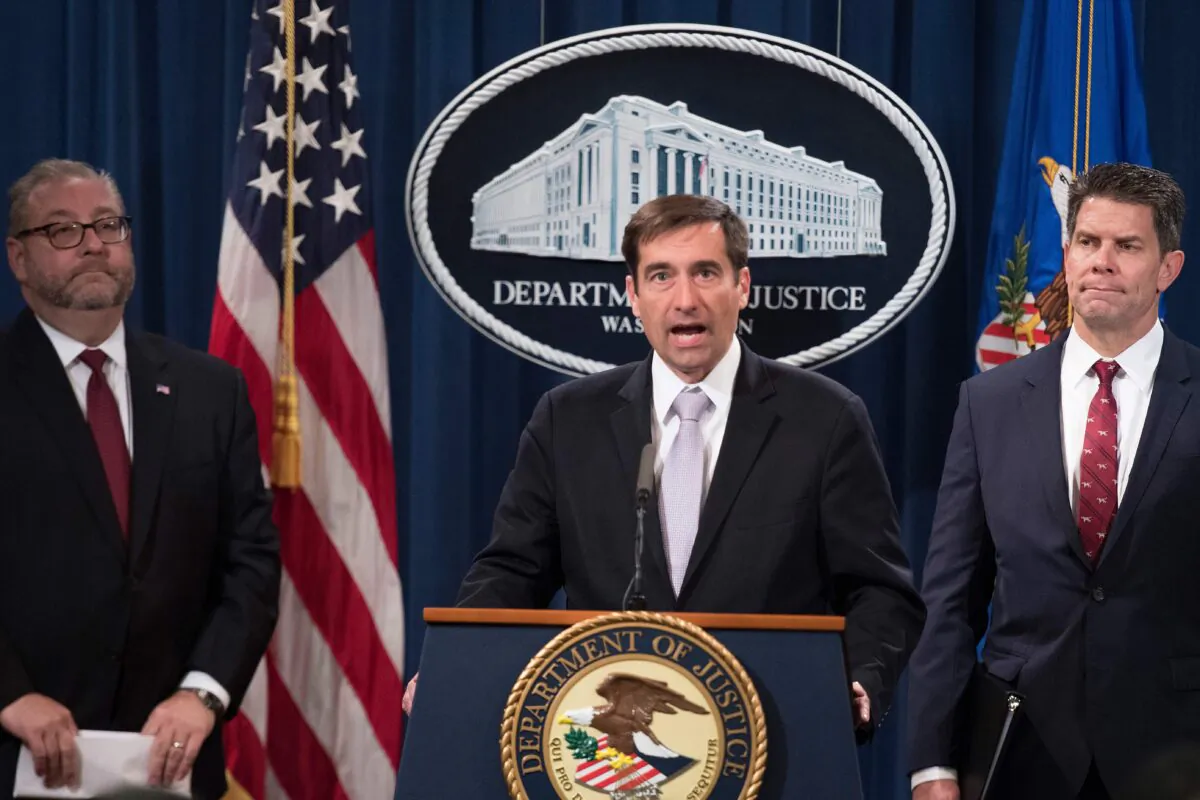 U.S. Assistant Attorney General for National Security John Demers (C) speaks during a press conference announcing the "China Initiative" to crack down on Chinese espionage at the Justice Department in Washington, DC, on November 1, 2018.        (JIM WATSON/AFP/Getty Images)