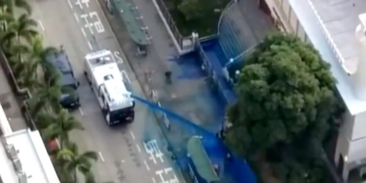 Camera equipped on The Epoch Times' drone shoots the moment police fired a water cannon at the Kowloon Masjid and Islamic Center with blue dye when a few people were standing in front of it on Oct. 20, 2019. (The Epoch Times)