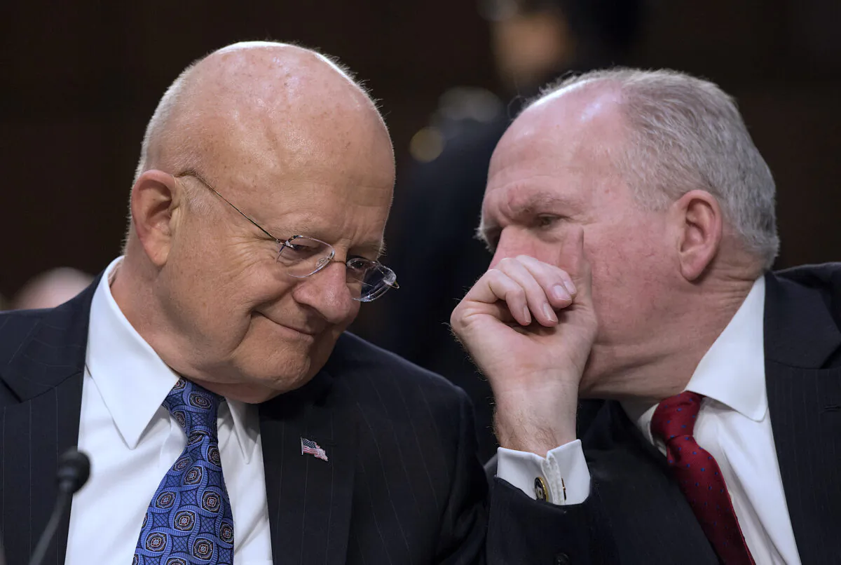 Director of National Intelligence James Clapper (L) and CIA Director John Brennan chat before testifying before the Senate Intelligence Committee on Feb. 9, 2016. (Molly Riley/AFP/Getty Images)