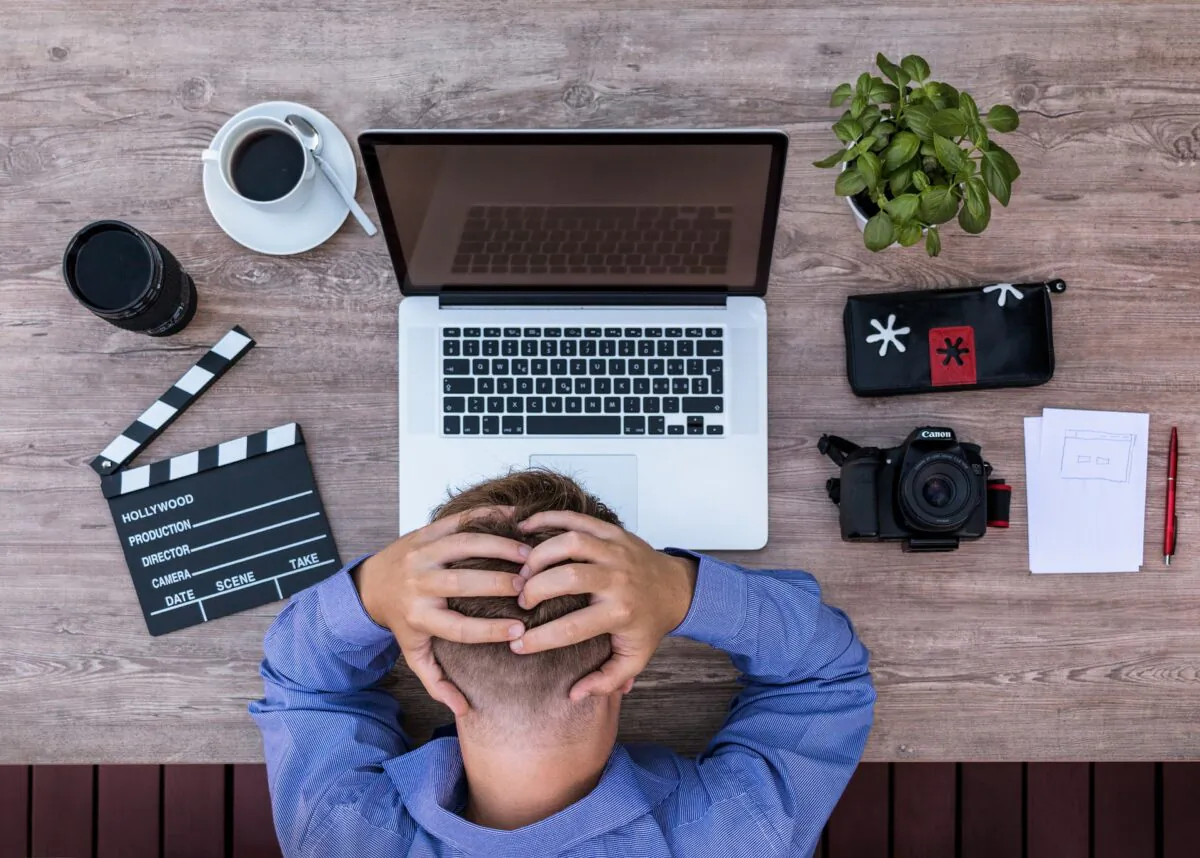 A frustrated writer stares at his computer in this file photo. Freelance writers in California are limited by a new bill to only 35 submissions per publication. (Lukas Bieri/Pixabay)