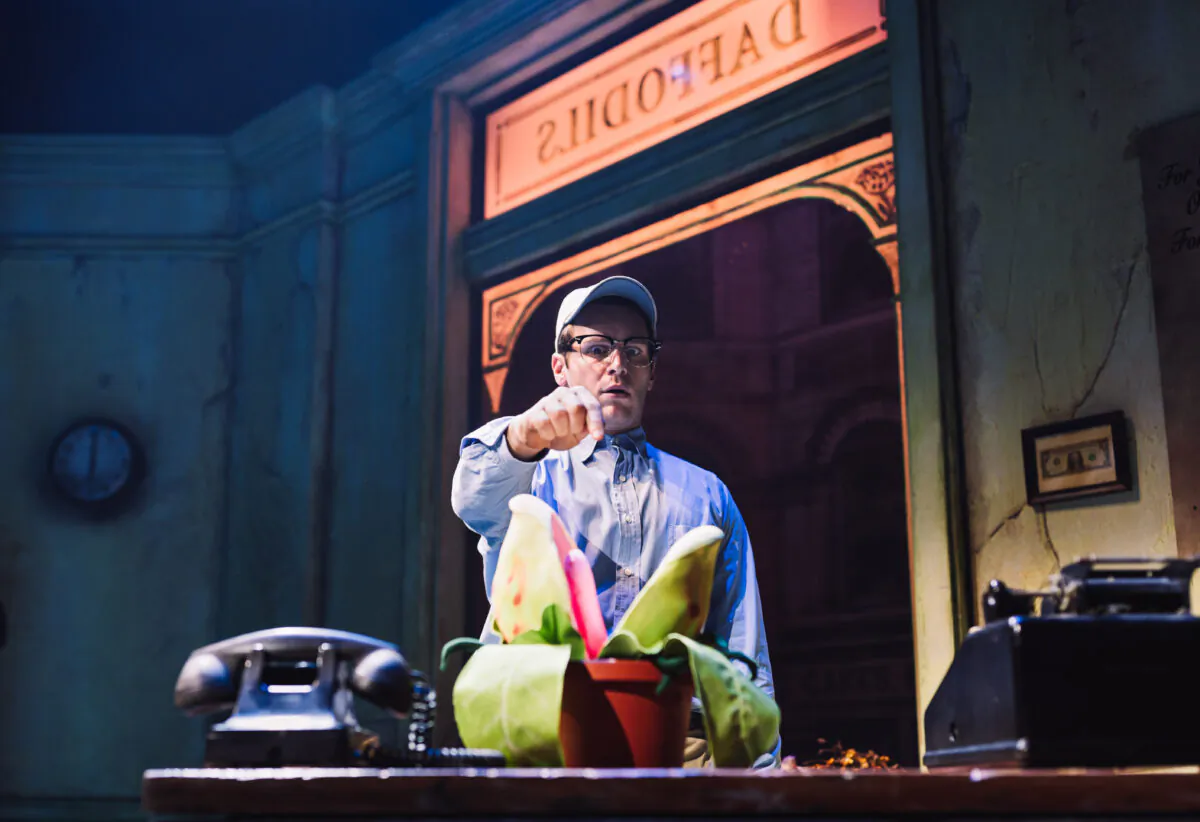 Seymour (Jonathan Groff) feeding Audrey II, in “Little Shop of Horrors.” (Emilio Madrid-Kuser)