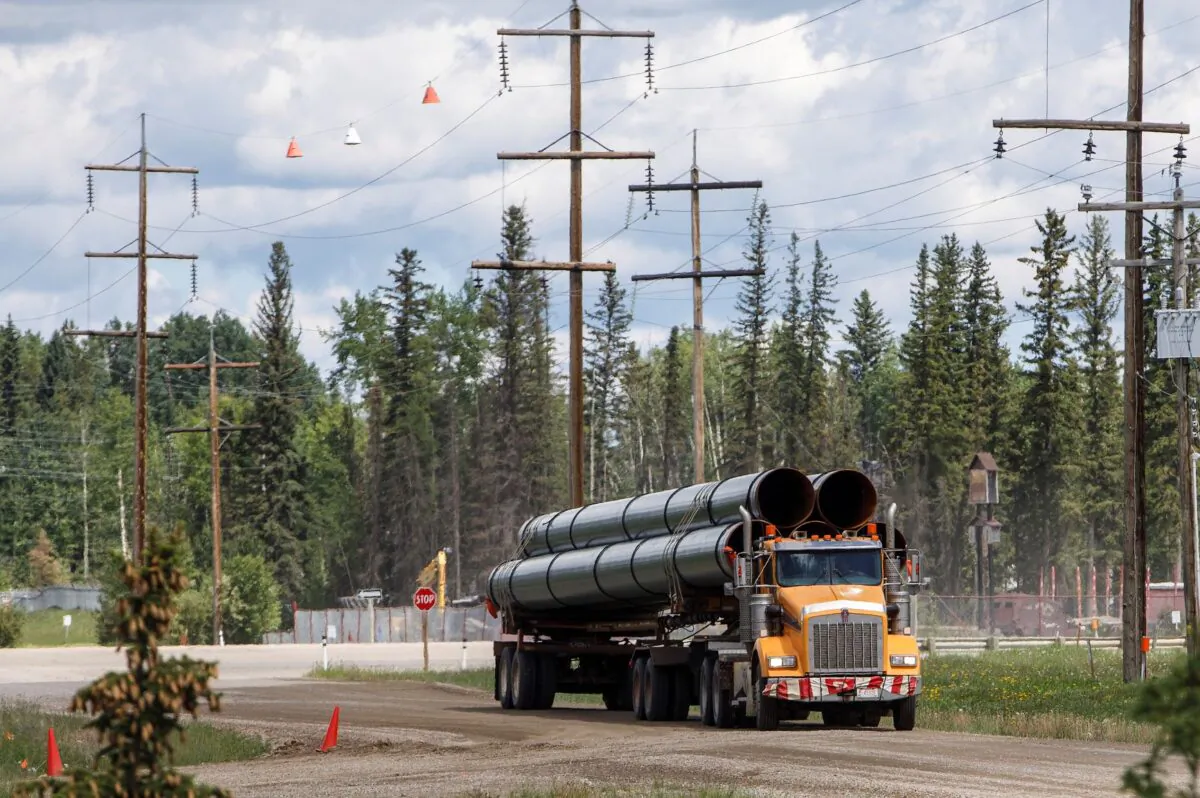 A truck carries pipes in Edson, Alta., on June 18, 2019.  (Jason Franson/The Canadian Press)