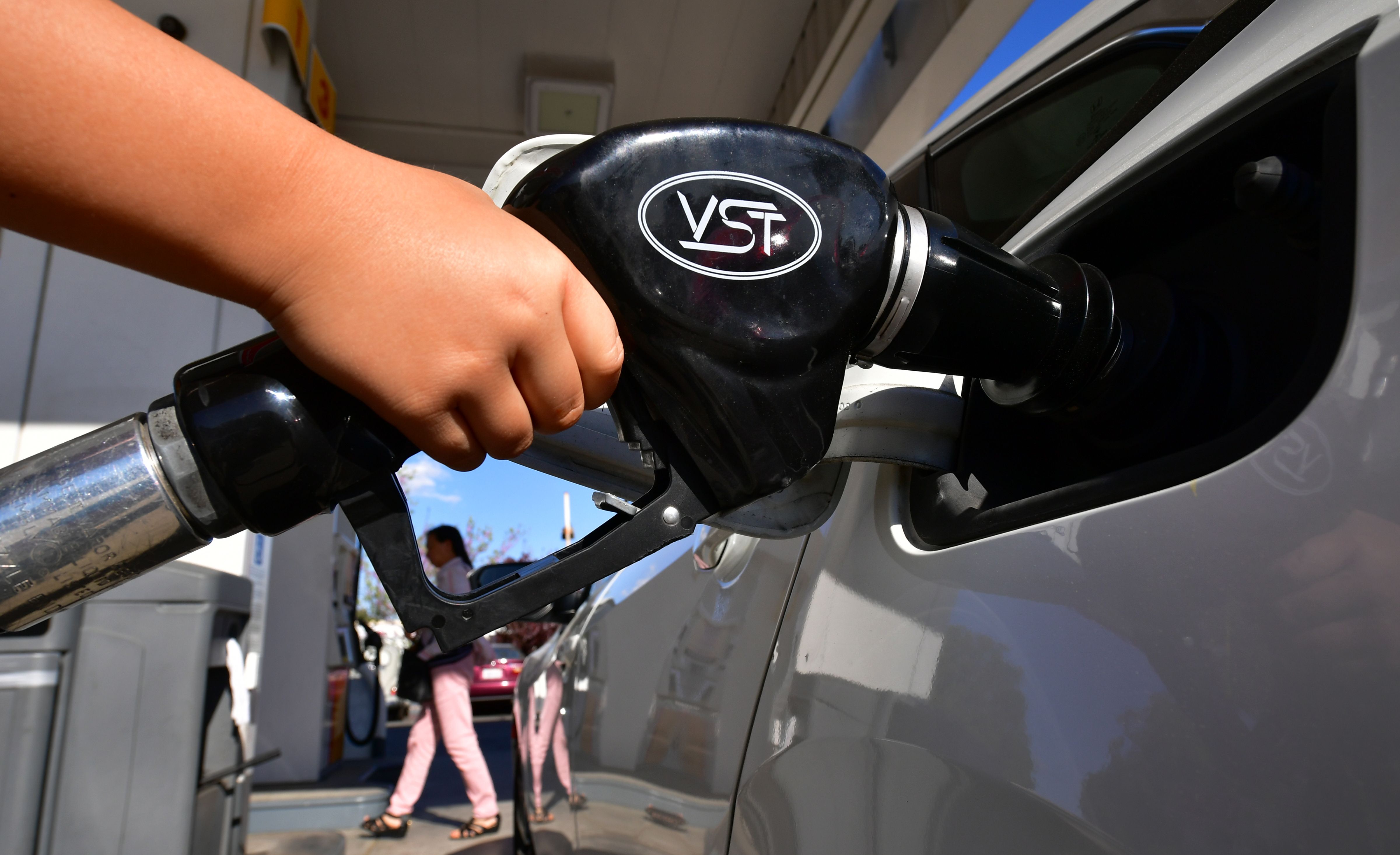 A child pumps gas