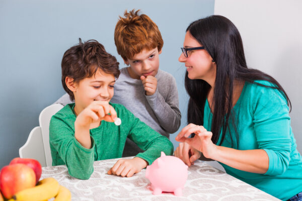 Mother is teaching her sons how to save money