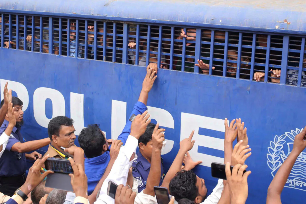Accused people are seen inside a prison van after they were given death sentences in a murder case in Feni, Bangladesh on Oct. 24, 2019. (Stringer/Reuters)