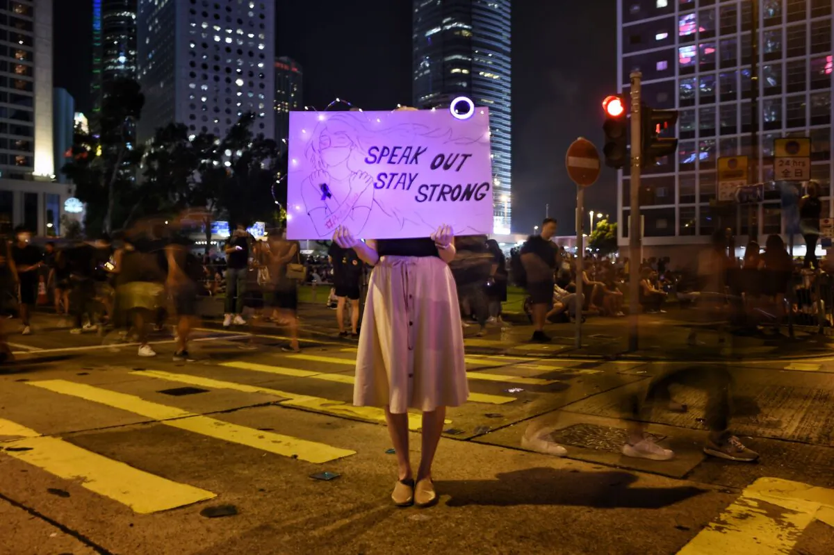A protester holds a sign at a #MeToo rally to protest alleged sexual assaults by police against pro-democracy female protesters, in Hong Kong on Aug. 28, 2019. (Lillian Suwanrumpha/AFP/Getty Images)