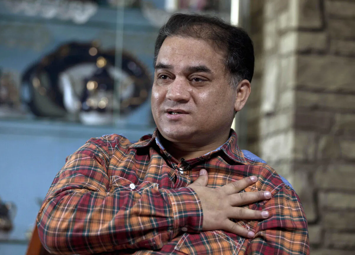 Ilham Tohti, an outspoken scholar of China's Turkic Uyghur ethnic minority, speaks during an interview at his home in Beijing, China on Feb. 4, 2013. (Andy Wong/AP)