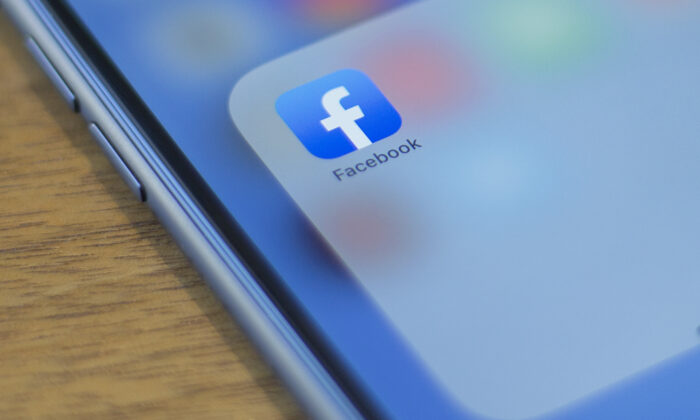 The Facebook logo is seen on a phone in this photo illustration in Washington on July 10, 2019. (ALASTAIR PIKE/AFP/Getty Images)