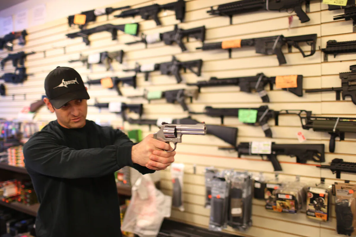 A salesman shows a customer a handgun in Delray Beach, Florida, on Jan. 5, 2016.  (Joe Raedle/Getty Images)