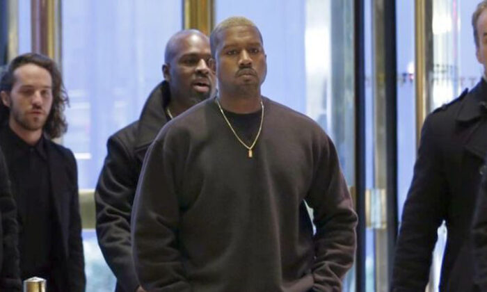 Kanye West enters Trump Tower in New York, Tuesday, Dec. 13, 2016. (AP Photo/Seth Wenig)