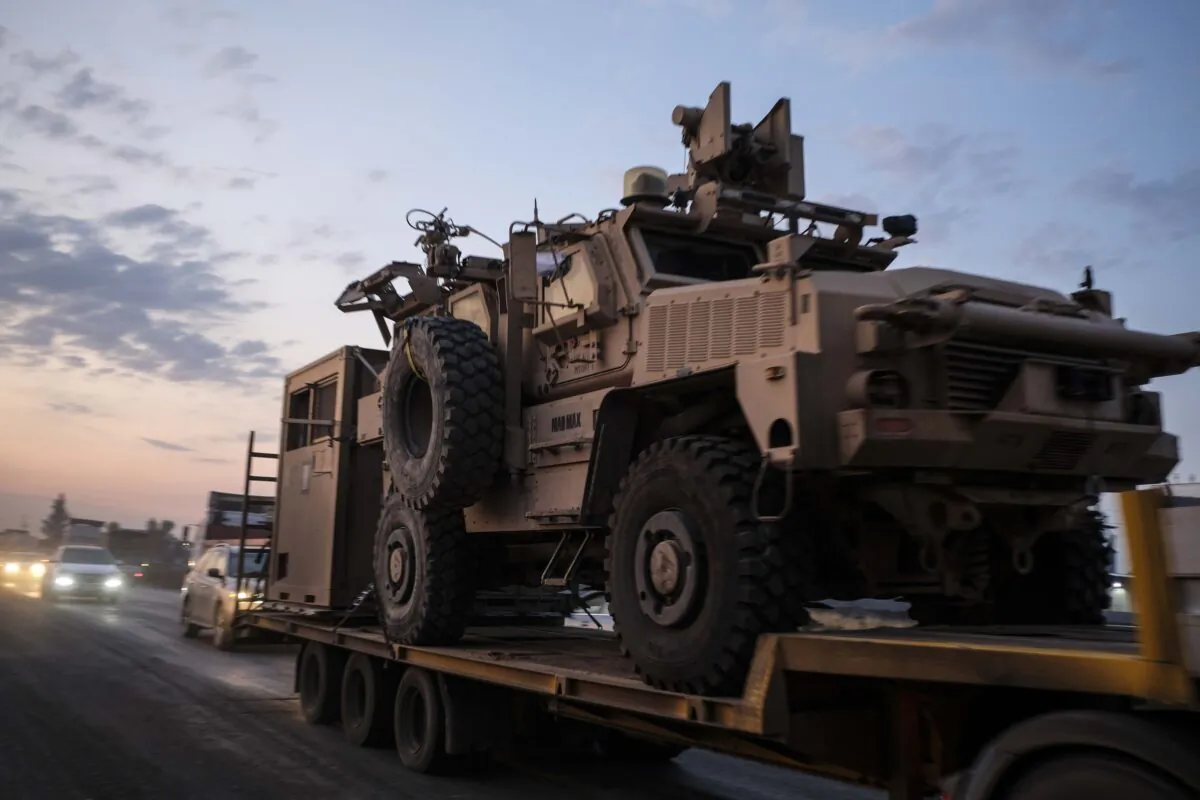A convoy of U.S. armored military vehicles leave Syria on a road to Iraq in n Sheikhan, Iraq on Oct. 19, 2019. (Photo by Byron Smith/Getty Images)