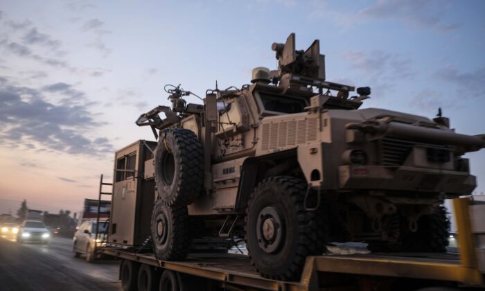 A convoy of U.S. armored military vehicles leave Syria on a road to Iraq in n Sheikhan, Iraq on Oct. 19, 2019. (Photo by Byron Smith/Getty Images)