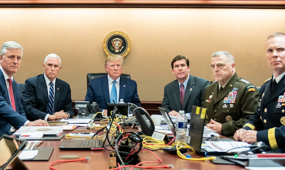 Pictured in the photo with the president was Vice President Mike Pence, National Security Advisor Robert O’Brien, Secretary of Defense Mark Esper, Chairman of the Joint Chiefs of Staff U.S. Army General Mark A. Milley, and Deputy Director for Special Operations Brig. Gen. Marcus Evans. (White House)

