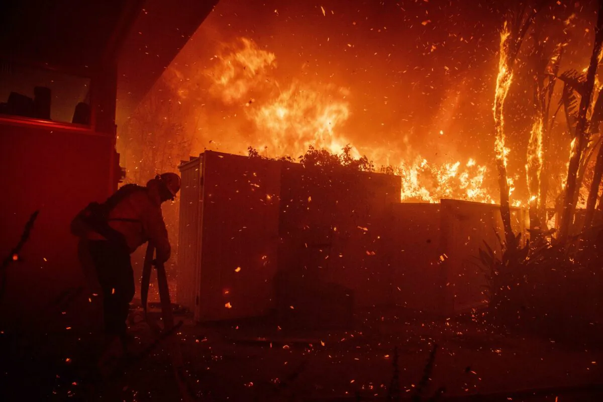 Firefighters try to save a home on Tigertail Road from the Getty fire, in Los Angeles, Calif., on Oct. 28, 2019. (Christian Monterrosa/AP Photo)