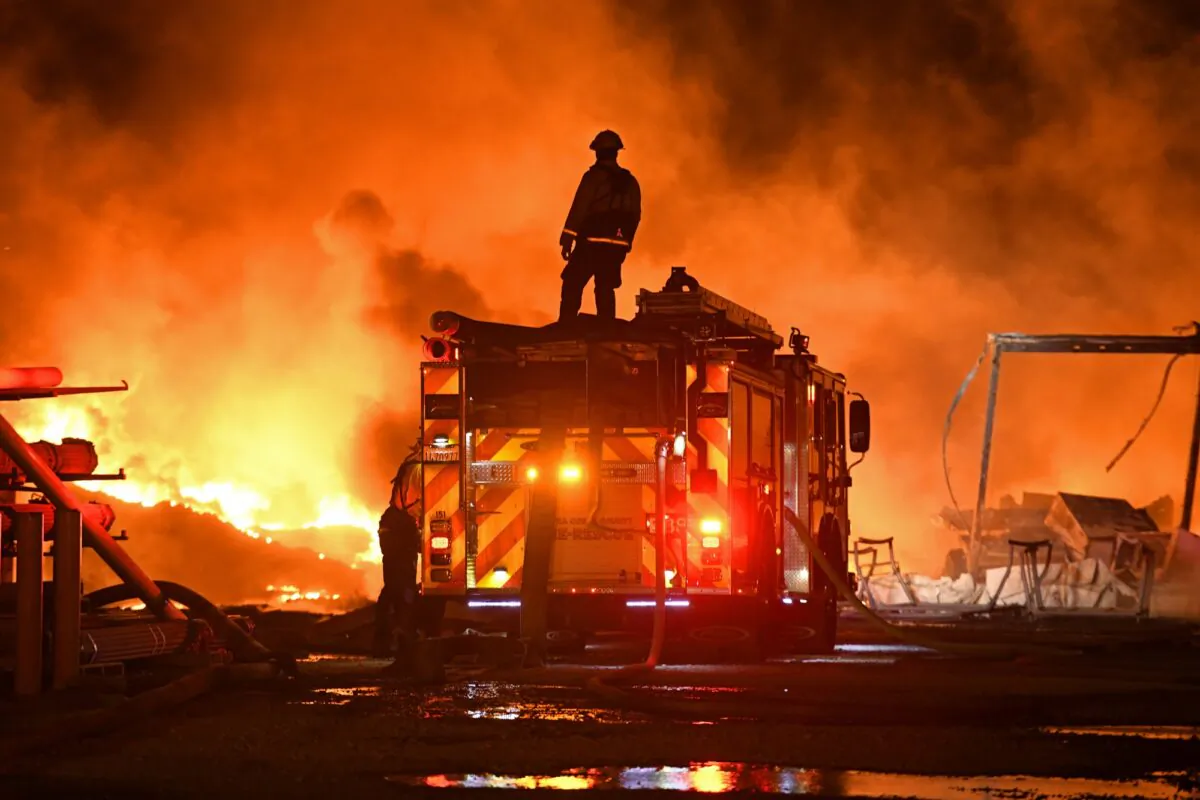 A firefighter stops to look at a wall of fire while battling a grass fire on East Cypress Road in Knightsen, Calif., on Oct. 27, 2019. (Jose Carlos Fajardo/Bay Area News Group/San Jose Mercury News via AP)