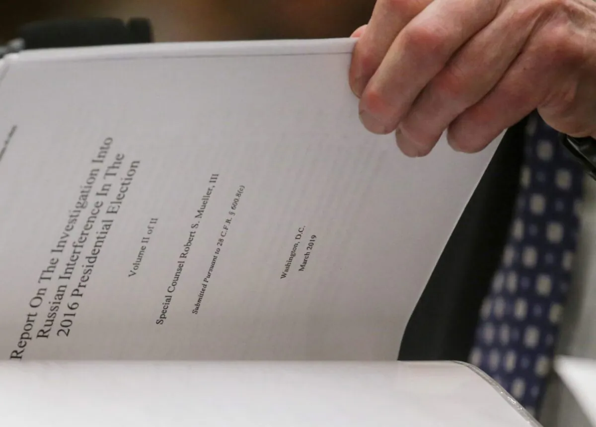 Former Special Counsel Robert Mueller references a copy of his report as he testifies before a House Judiciary Committee hearing on the Office of Special Counsel's investigation into Russian Interference in the 2016 Presidential Election on Capitol Hill in Washington on July 24, 2019. (Leah Millis/File Photo/Reuters)