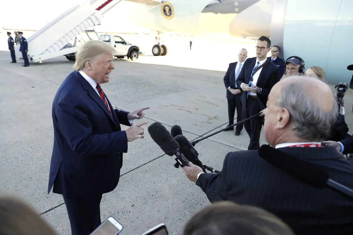 President Donald Trump talks to reporters before boarding Air Force One for a trip to Chicago to attend the International Association of Chiefs of Police Annual Conference and Exposition at Andrews Air Force Base, Md., on Oct. 28, 2019. (AP Photo/Evan Vucci)