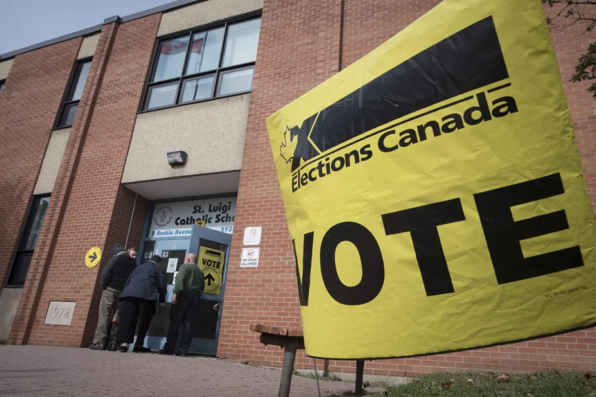 Voters enter the polling station at St. Luigi Catholic School in Toronto on Oct. 21, 2019. (THE CANADIAN PRESS/ Tijana Martin)