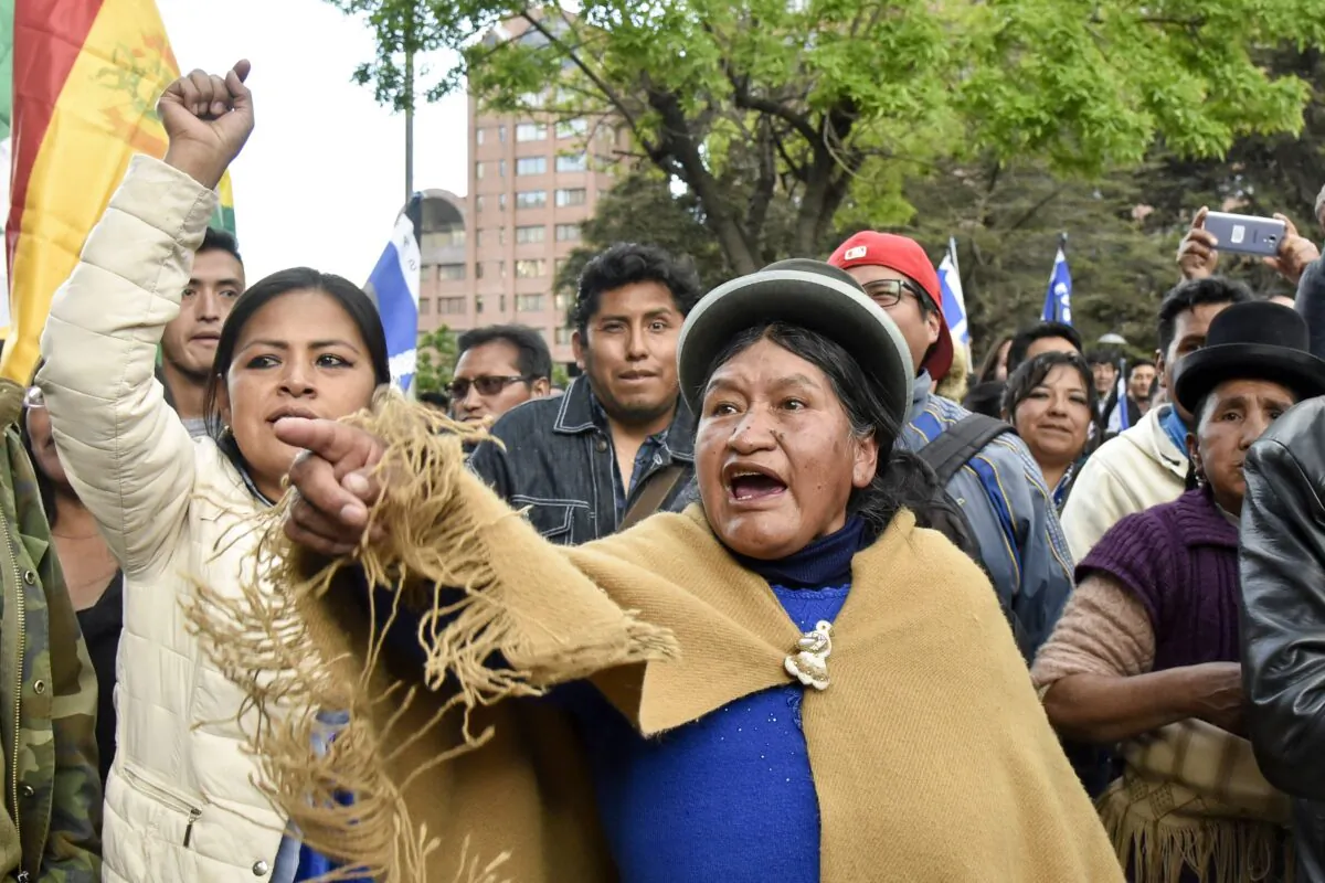 Supporters of Bolivia's president and candidate Evo Morales demonstrate against the main opposition candidate, former president (2003-2005) Carlos Mesa, as supporters of both groups gather outside the hotel where the Supreme Electoral Tribunal has its headquarters to count the election votes, in La Paz, on October 21, 2019. (AIZAR RALDES/AFP via Getty Images)
