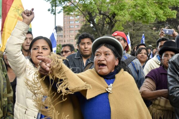 Supporters of Bolivia's president and candidate Evo Morales demonstrate against the main opposition candidate, former President (2003-2005) Carlos Mesa, as supporters of both groups gather outside the hotel where the Supreme Electoral Tribunal has its headquarters to count the election votes, in La Paz, on Oct. 21, 2019. (AIZAR RALDES/AFP via Getty Images)