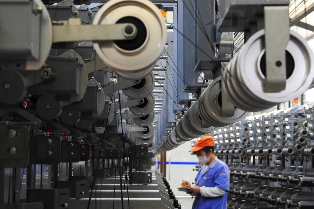 An employee works at a carbon fiber production line inside a factory in Lianyungang, Jiangsu Province, China on Oct. 27, 2018. (Reuters)