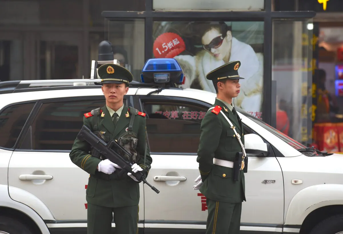 Chinese paramilitary police officers watch over pedestrians in the Wangfujing shopping district in Beijing on Oct. 24, 2014. China's Communist rulers declared that the country would embrace the "rule of law with Chinese characteristics," official media reported after a key party meeting touted as heralding legal reform. (Greg Baker/AFP/Getty Images)