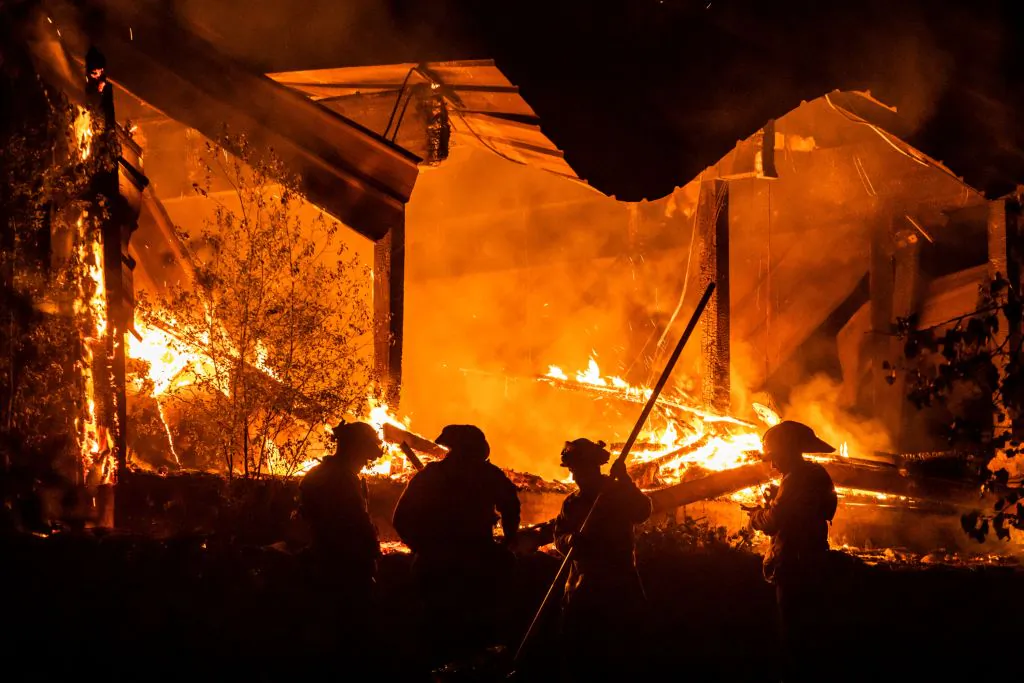 Firefighters tend to a structure lost during the Kincade fire off Highway 128, east of Healdsburg, Calif., on Oct. 29, 2019. (Philip Pacheco/AFP via Getty Images)