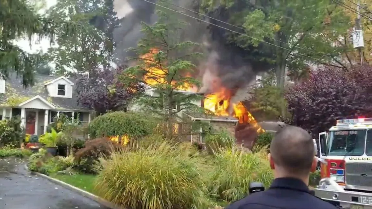 One of the two houses that caught fire after a small plane crashed into the house in the Colonia section of Woodbridge Township, N.J., on Oct. 29, 2019. (Video screenshot/ Michael Yonone via Reuters)