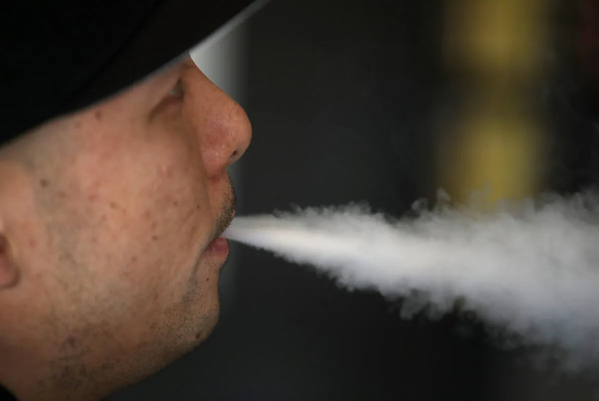 A man blows vapor from an e-cigarette in South San Francisco, Calif., on Jan. 23, 2018. (Justin Sullivan/Getty Images)