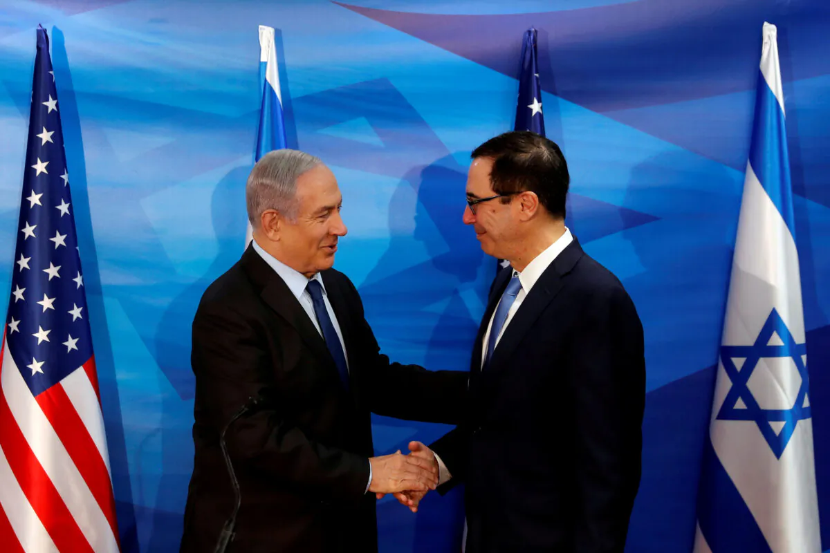 Israeli Prime Minister Benjamin Netanyahu and U.S. Treasury Secretary Steven Mnuchin shake hands as they deliver joint statements during their meeting in Jerusalem on Oct. 28, 2019. (Ronen Zvulun/Reuters)