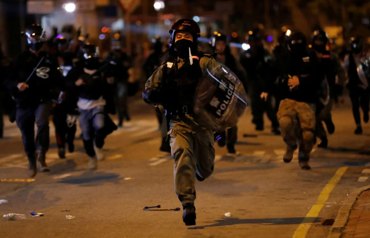 Riot police member runs to detain a protester during an anti-government rally in Hong Kong, China on Oct. 30, 2019. (Kim Kyung-Hoon/Reuters)