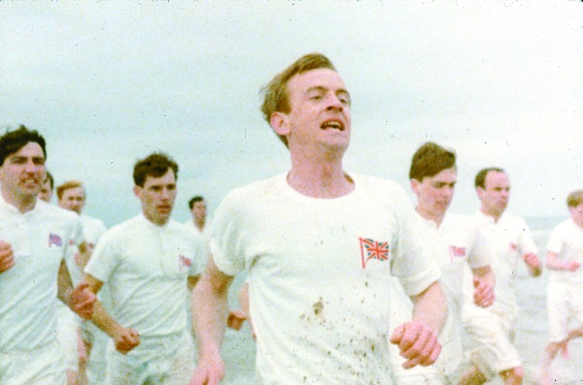 men in white running on beach