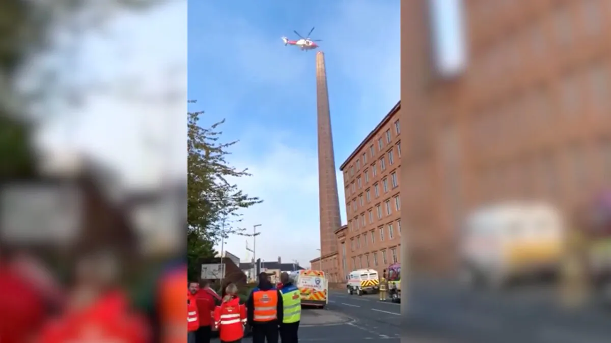 A man hangs upside down from the top of Dixon's Chimney in Carlisle, United Kingdom, on Oct. 28, 2019. (Danny Lawson/AP)