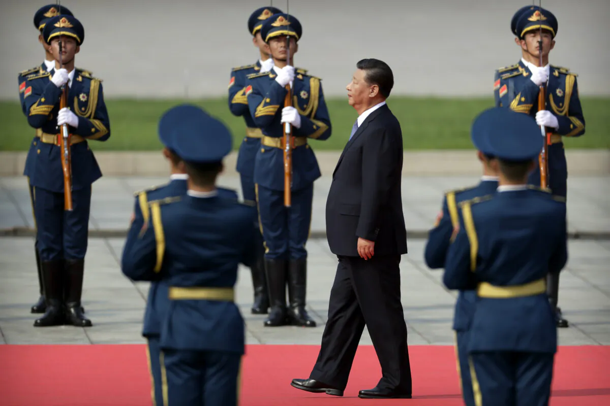 Chinese leader Xi Jinping walks past an honor guard as he approaches the Monument to the People's Hereos during a ceremony to mark Martyr's Day at Tiananmen Square in Beijing on Sept. 30, 2019. (Mark Schiefelbein-Pool/Getty Images)