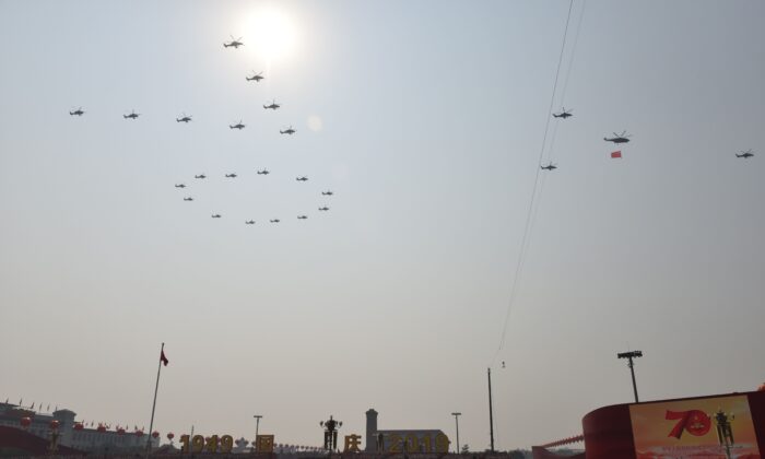 Helicopters fly in formation to create the number 70 during a military parade at Tiananmen Square in Beijing to mark the 70th anniversary of the founding of Chinese Communist regime on Oct. 1, 2019. The three military officers who died in the fatal helicopter crash during a Hong Kong military drill participated in this formation. (Greg Baker/AFP via Getty Images)