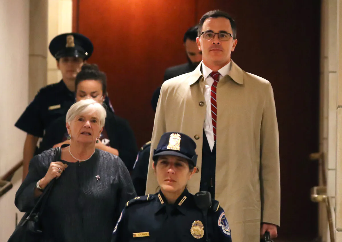 Timothy Morrison,(R), National Security Council's Russia and Europe Director, is escorted to a closed-door deposition in Washington, on Oct. 31, 2019. (Mark Wilson/Getty Images)