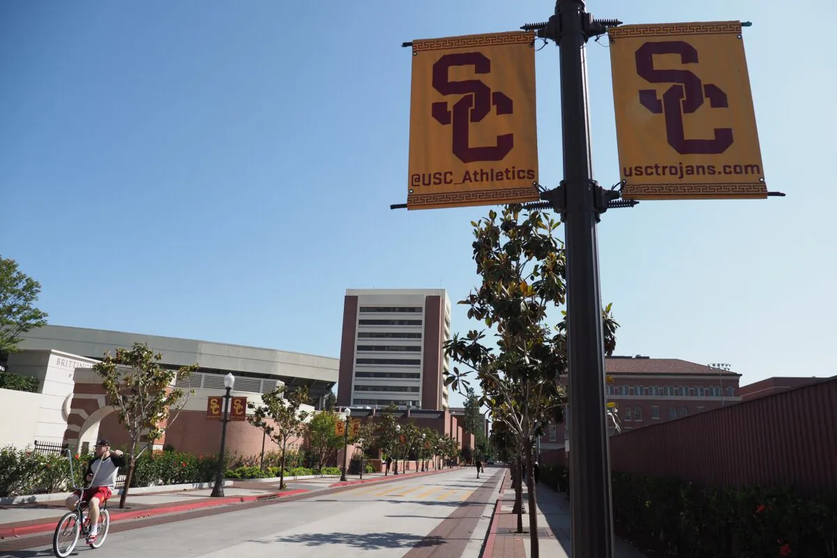 A young man rides a bicycle on the campus of the University of Southern California (USC) in Los Angeles, Calif., on May 17, 2018. (Robyn Beck/AFP via Getty Images)