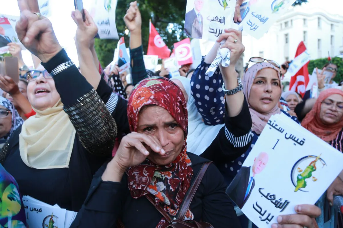 Supporters of Tunisian presidential candidate Kais Saied campaign in Tunis on Oct. 11, 2019. The frontrunner in Tunisia's presidential election runoff will go head-to-head tonight against his rival in a rare and highly anticipated televised debate just two days ahead the vote. Political newcomers Kais Saied, 61, an independent conservative academic, and business tycoon Nabil Karoui, 56, won through the first round of the poll in September, sweeping aside the country's post-Arab Spring establishment. (ANIS MILI/AFP via Getty Images)