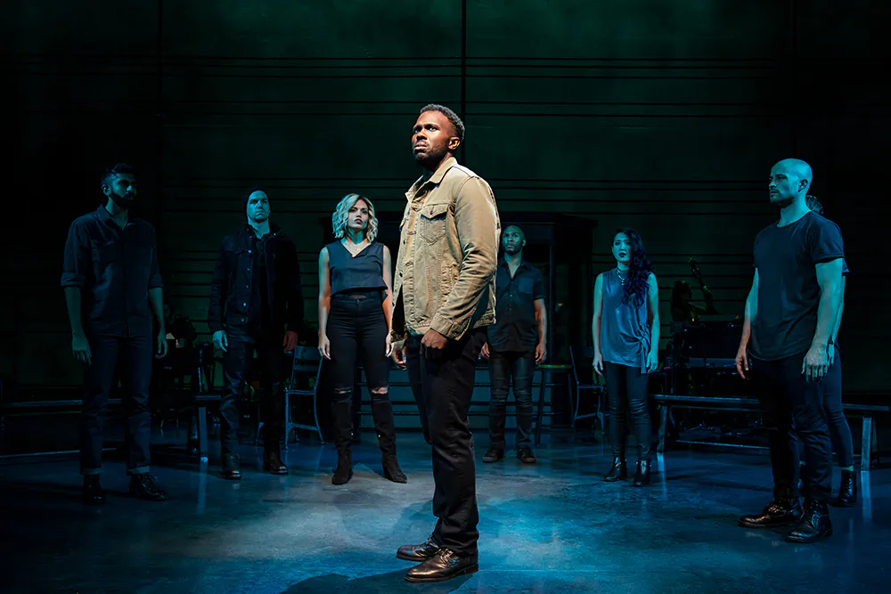 Joshua Henry (C) surrounded by the cast of “The Wrong Man.” (Matthew Murphy)